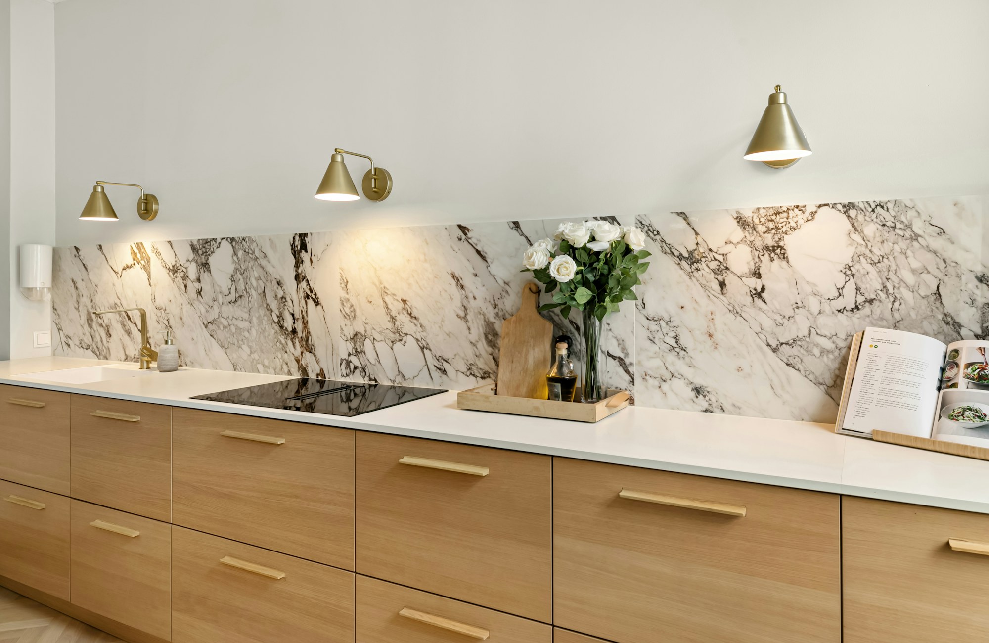 Kitchen with honed stone counters and oak cabinetry
